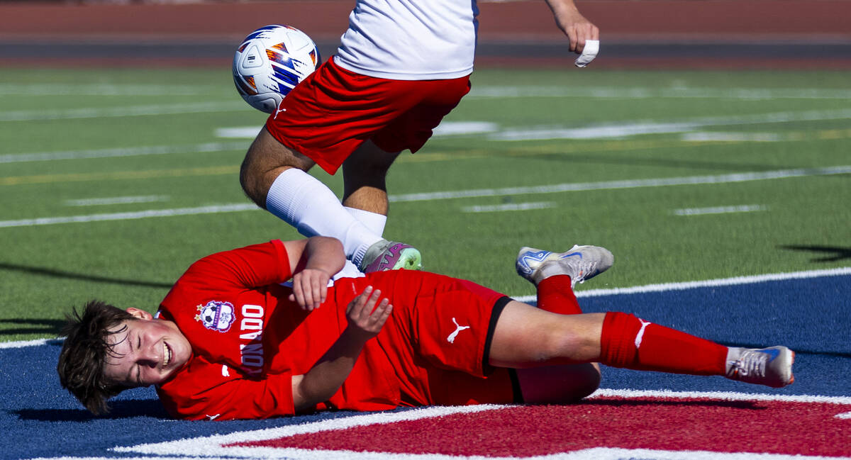 Coronado midfielder Aiden Sena (10) goes down after a sliding kick attempt against a Wooster de ...