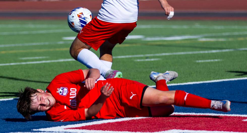 Coronado midfielder Aiden Sena (10) goes down after a sliding kick attempt against a Wooster de ...