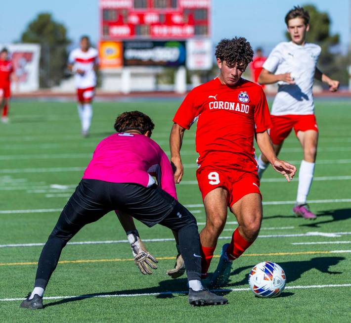 Coronado striker Dylan Flores (9) maneuvers past Wooster goalkeeper Jason Acosta Plascencia (1) ...