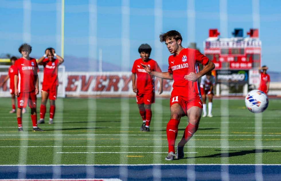 Coronado striker Gavin Flickinger (11) scores against Wooster on a penalty kick to set a state ...