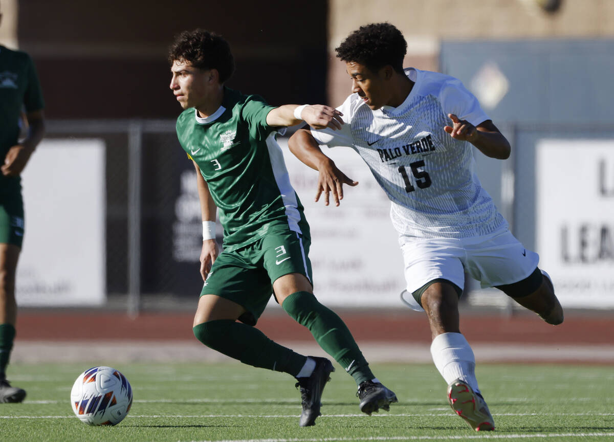 Hug High's defender Jordan Gomez (3) protects the ball from Palo Verde High's forward Trevon Ay ...