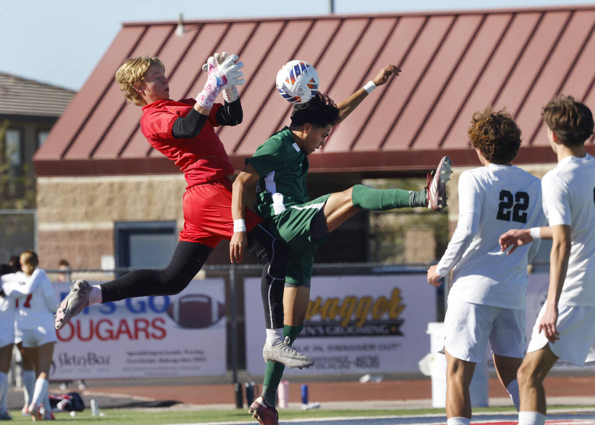 Palo Verde High's goalie Landon Blanchard jumps to block Hug High's Julian Enriquez (25) header ...