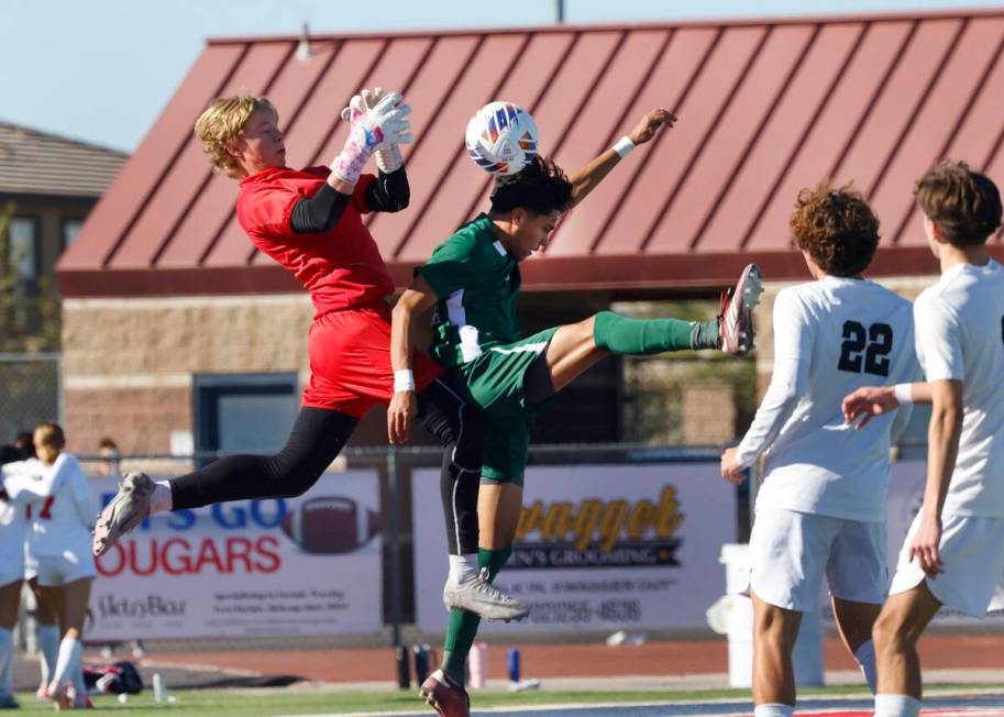 Palo Verde High's goalie Landon Blanchard jumps to block Hug High's Julian Enriquez (25) header ...