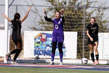 Coronado High's goalie Eden Grenier, center, reacts as Faith Lutheran's striker Julia Anfinson ...