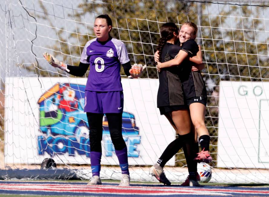 Coronado High's goalie Eden Grenier reacts as Faith Lutheran's striker Julia Anfinson, right, c ...