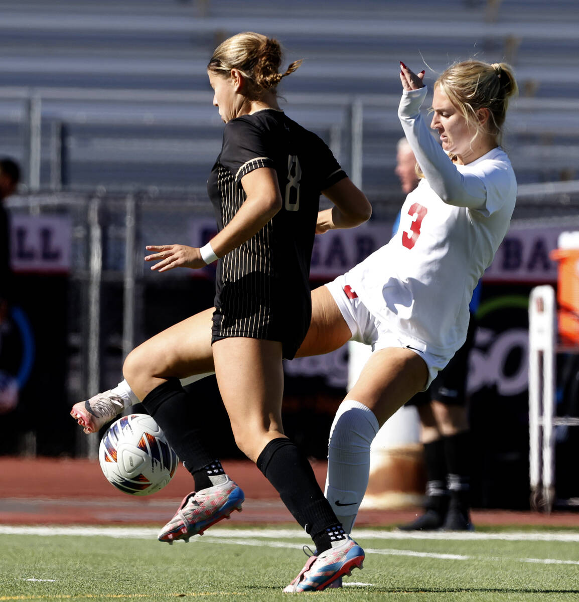 Faith Lutheran's forward Olivia Stark (8) and Coronado High's midfielder Alexandra Milano (3) f ...