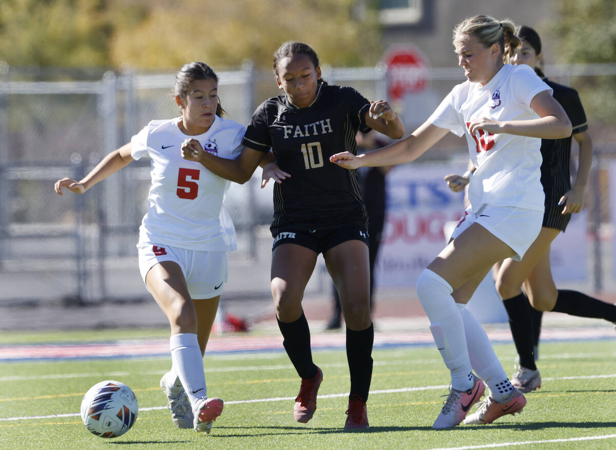 Faith Lutheran's forward Briana Lee (10) fights for the ball with Coronado High's forward Abby ...