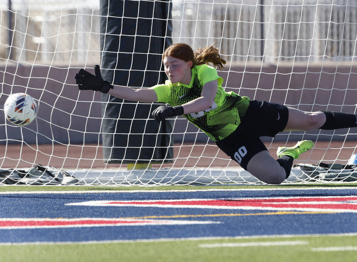 Coronado High's goalie Emma Duda dives but unable to stop Faith Lutheran's striker Julia Anfins ...