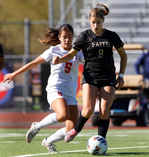 Faith Lutheran's forward Olivia Stark (8) drives past Coronado High's forward Abby Obregon (5) ...