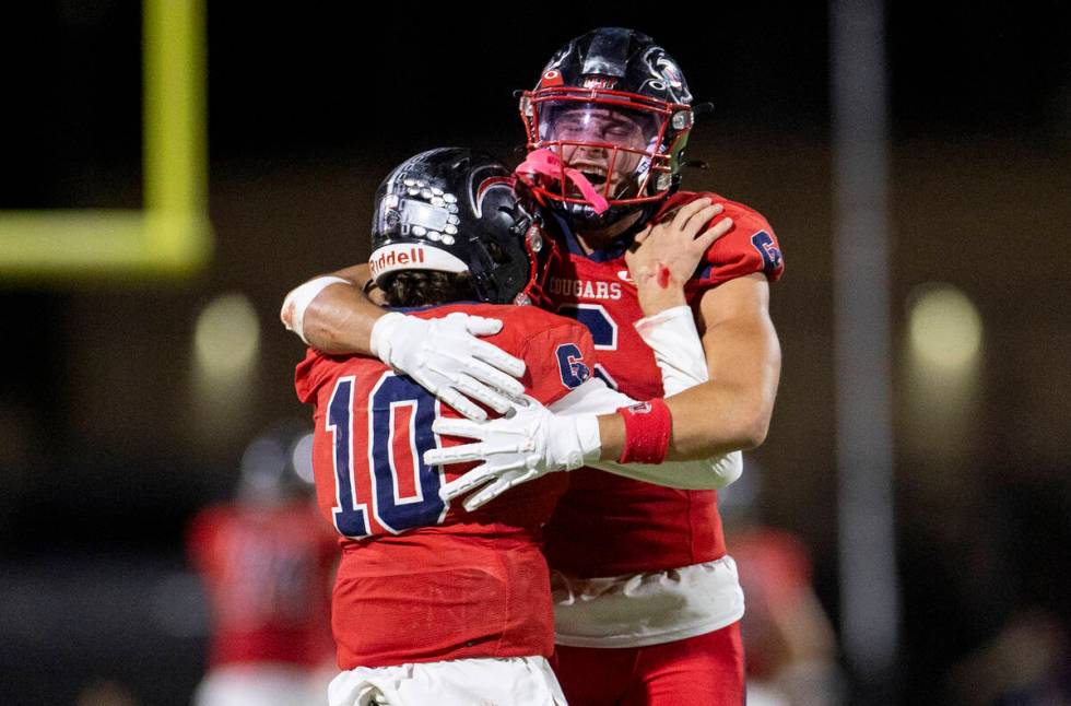 Coronado quarterback Aiden Krause (10) celebrates with senior JJ Buchanan (6) after throwing a ...