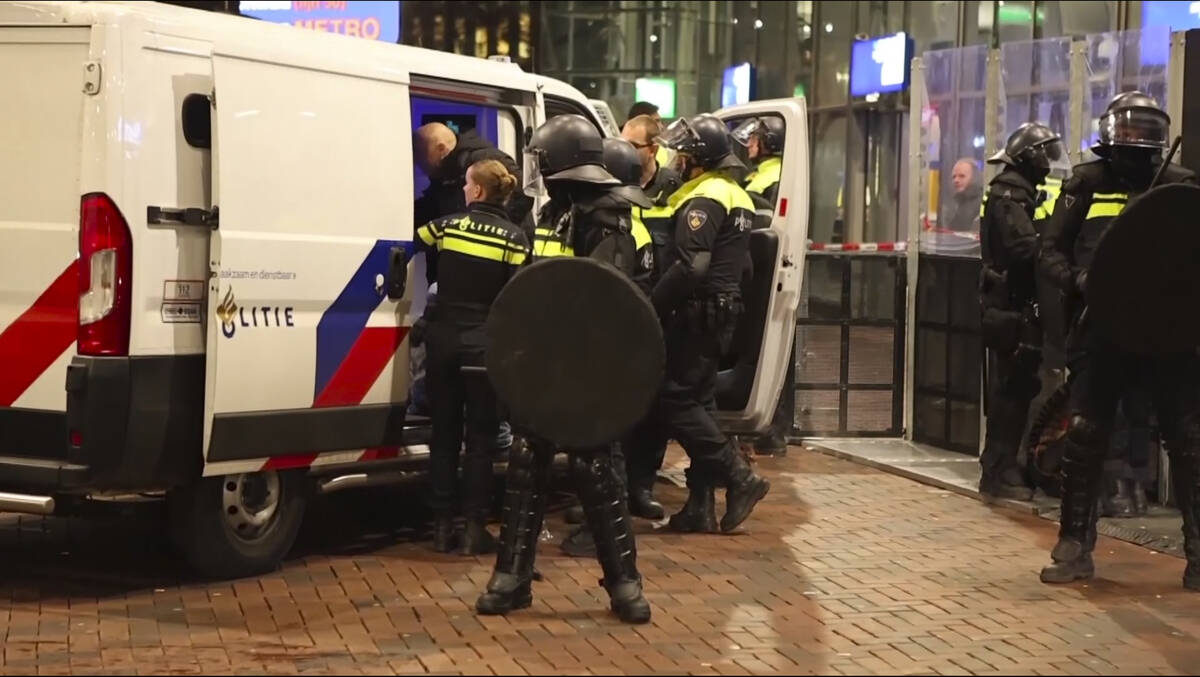 In this image taken from video, police detain a man near the Ajax stadium, after pro-Palestinia ...