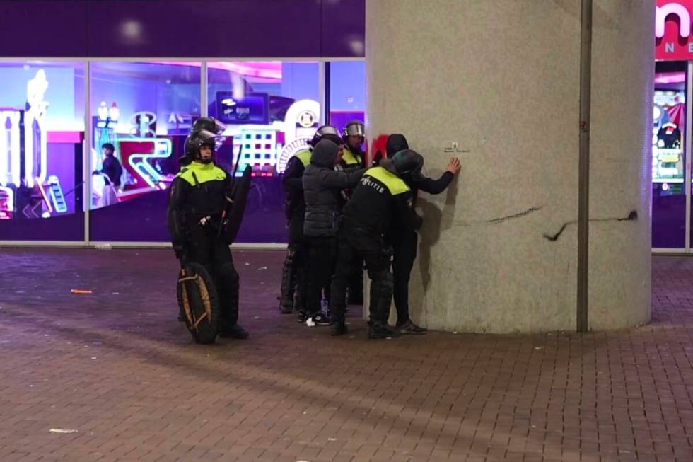 In this image taken from video, police frisk pro-Palestinian supporters near the Ajax stadium i ...