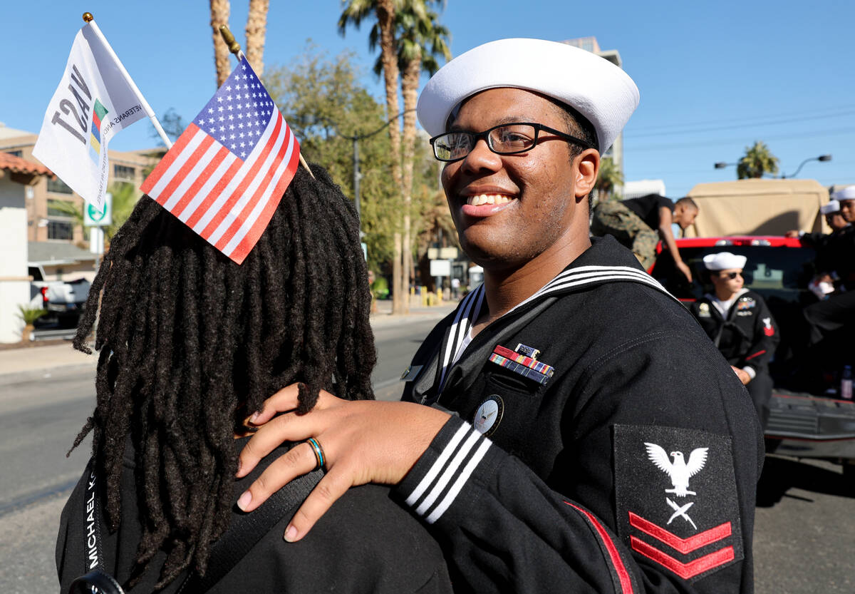 Navy Recruiter Romeo Anderson and his wife Kendraya Anderson prepare to march in the Las Vegas ...