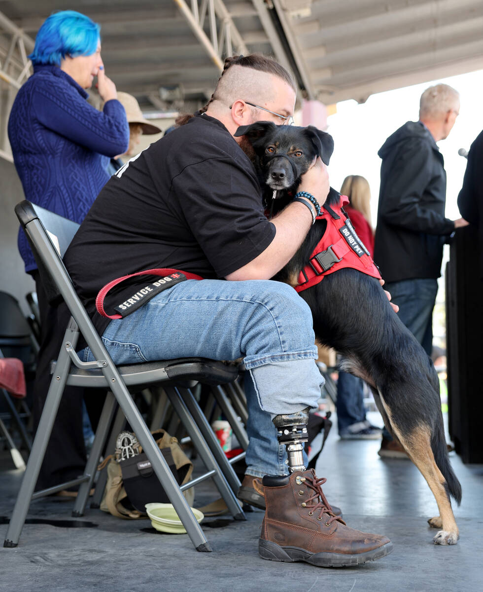 U.S. Army Sgt. Stanwix Austin Mcglaun and his service dog Birch Bark watch the Las Vegas Vetera ...