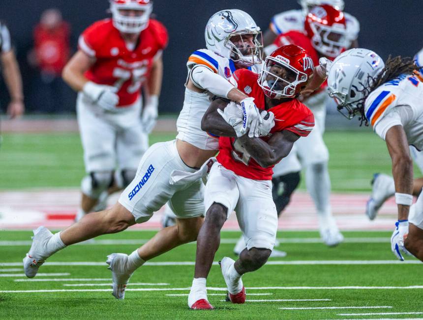 UNLV running back Jai'Den Thomas (9) battles for mare yards against the Boise State Broncos def ...