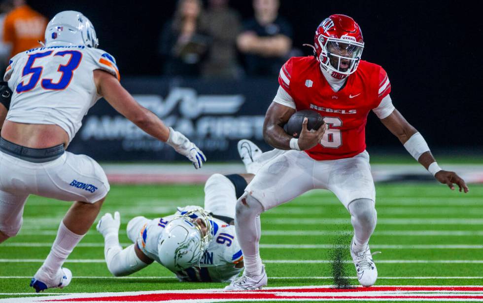 UNLV quarterback Hajj-Malik Williams (6) leaves Boise State Broncos defensive end Ahmed Hassane ...