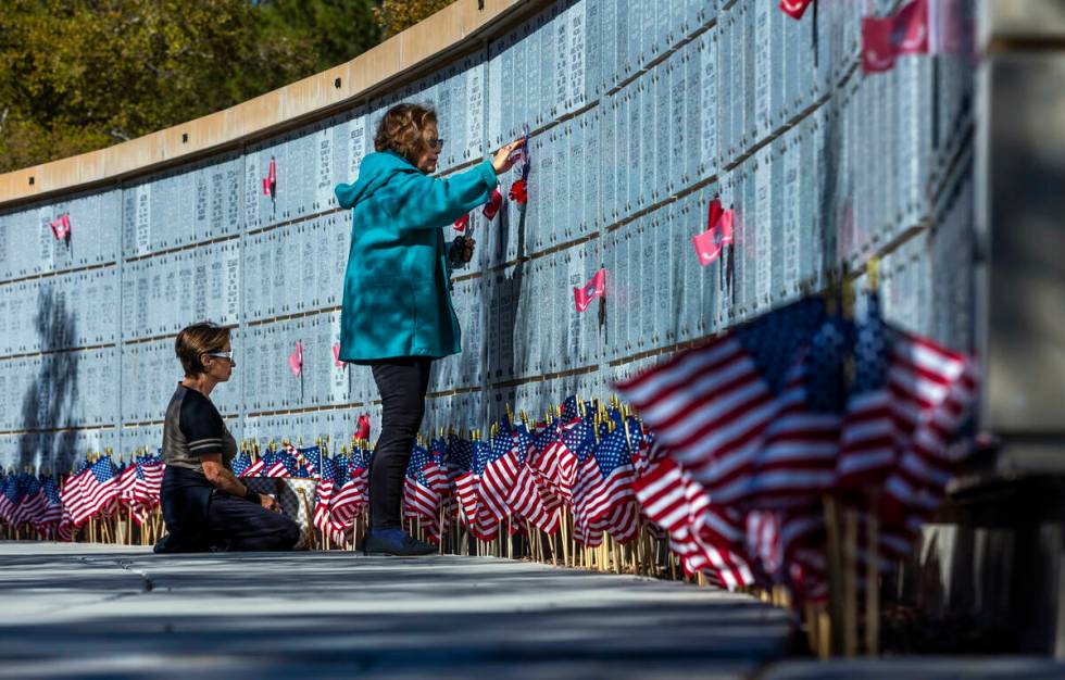 (From left) Jill D'Arpino reflects at the marker for her son Michael Kissel and Elise Tirado on ...