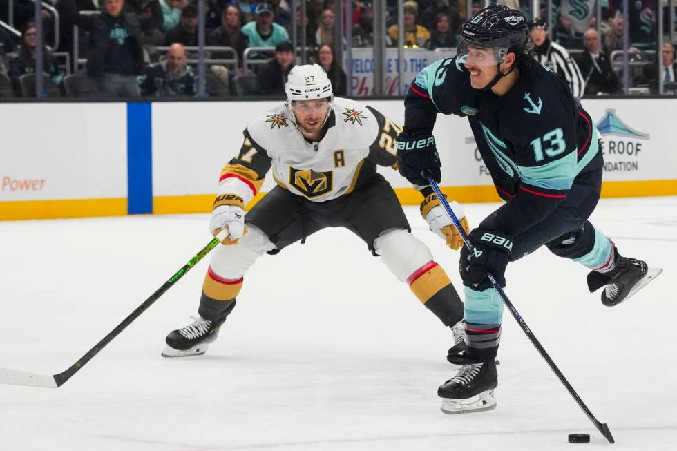 Seattle Kraken left wing Brandon Tanev (13) shoots and scores as Vegas Golden Knights defensema ...