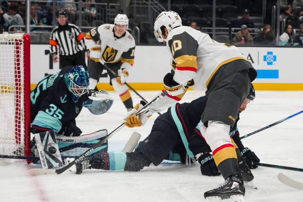 Seattle Kraken goaltender Joey Daccord (35) makes a save against Vegas Golden Knights center Ni ...