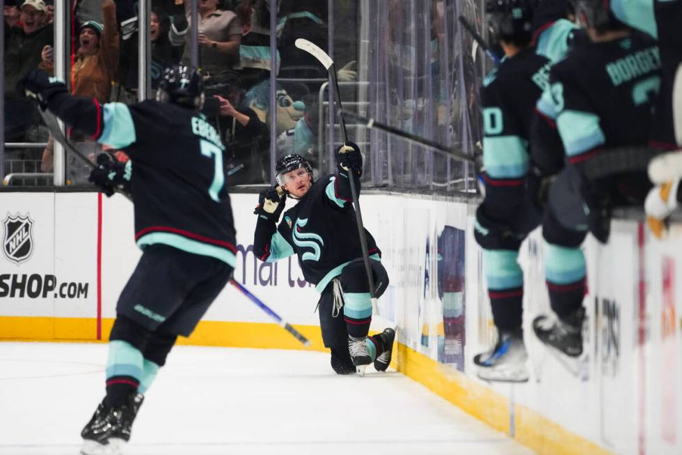 Seattle Kraken left wing Jared McCann, center, reacts to scoring the game-winning goal during o ...