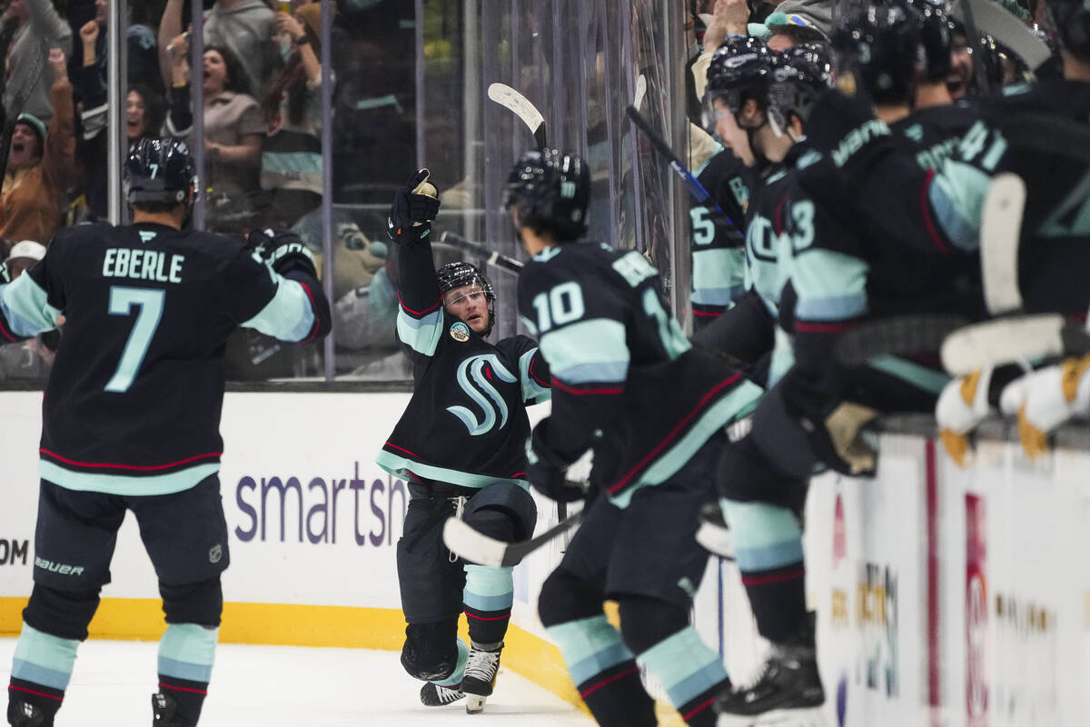 Seattle Kraken left wing Jared McCann, facing, reacts to scoring the game-winning goal during o ...