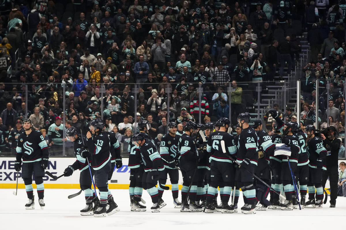 The Seattle Kraken celebrate their win in overtime against the Vegas Golden Knights in an NHL h ...