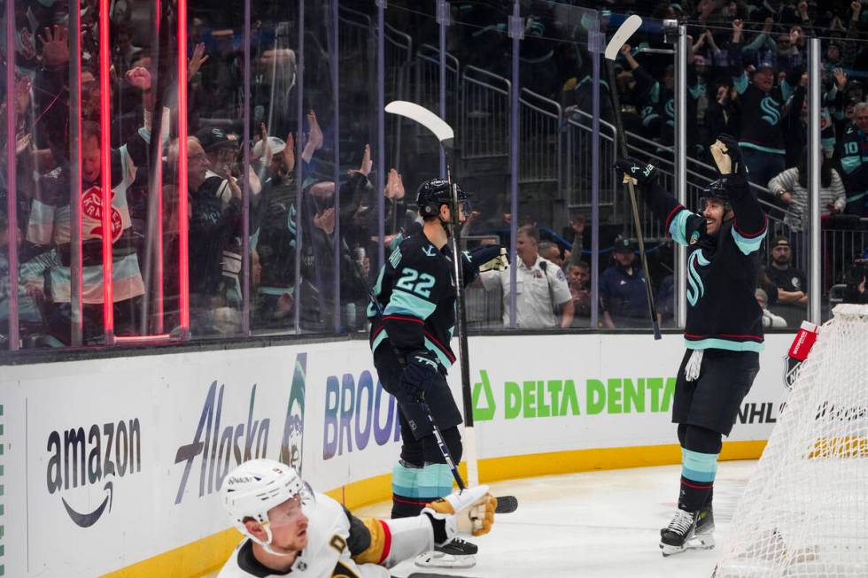 Seattle Kraken right wing Oliver Bjorkstrand (22) celebrates his goal with Chandler Stephenson, ...