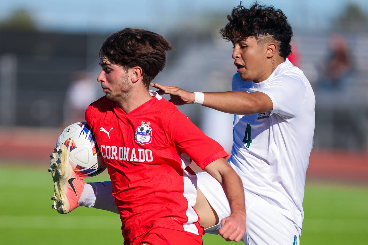 Coronado striker Gavin Flickinger (11) gets caught up with Hug defender Gael Ramirez (4) during ...