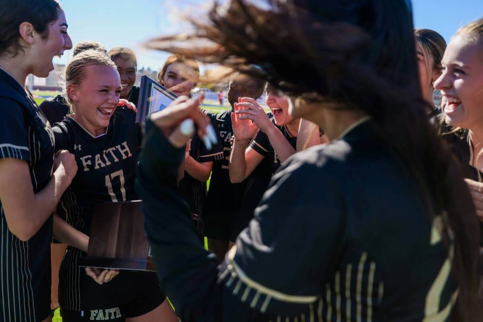 Faith Lutheran soccer players celebrate winning following a 5A girls soccer state championship ...