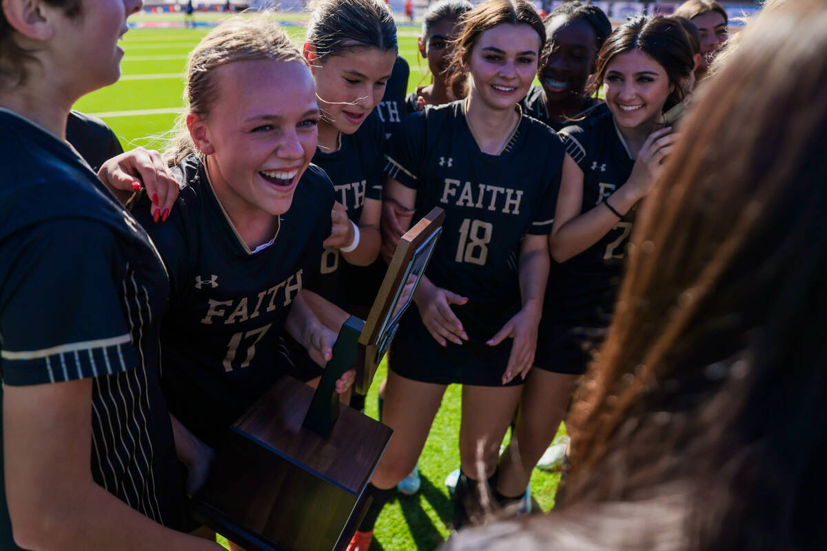 Faith Lutheran soccer players celebrate winning following a 5A girls soccer state championship ...