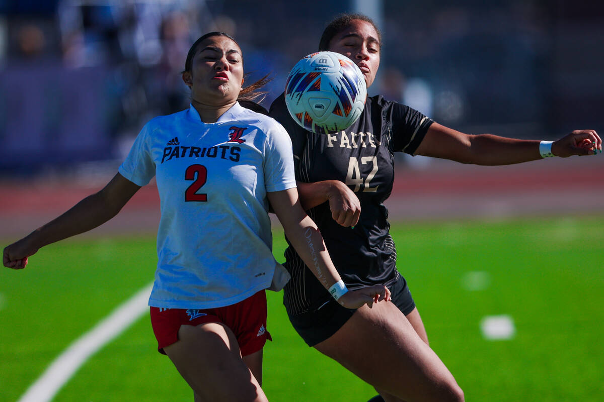 Liberty midfielder Natalie Collins (2) and Faith Lutheran Jailynn Henry (42) race up against th ...