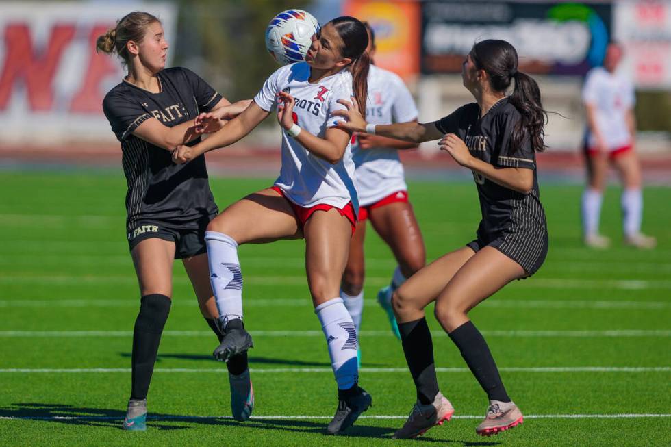 Liberty midfielder Natalie Collins (2) gets tangled up with the ball during a 5A girls soccer s ...