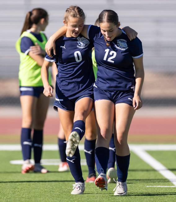 Centennial defender Kara Lorentz (0) and defender Calina Ritcharoen (12) dance before the 4A gi ...