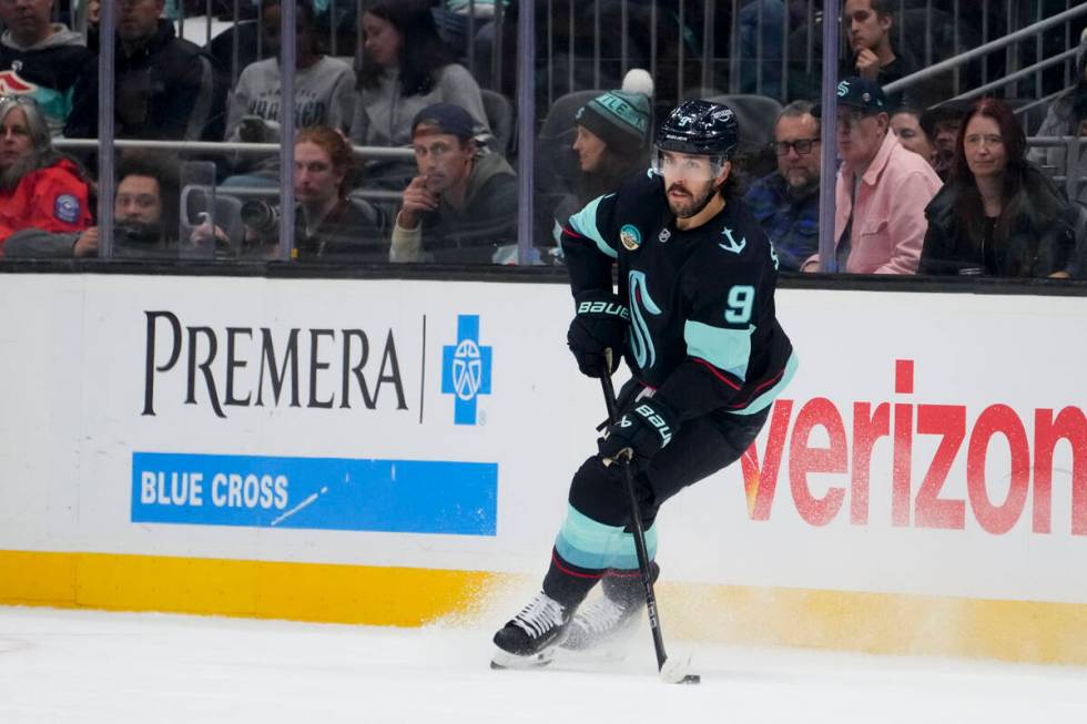 Seattle Kraken center Chandler Stephenson (9) moves the puck against the Winnipeg Jets during t ...