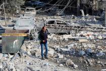 A resident checks the site of an Israeli airstrike in Tyre, southern Lebanon, Saturday, Nov. 9, ...