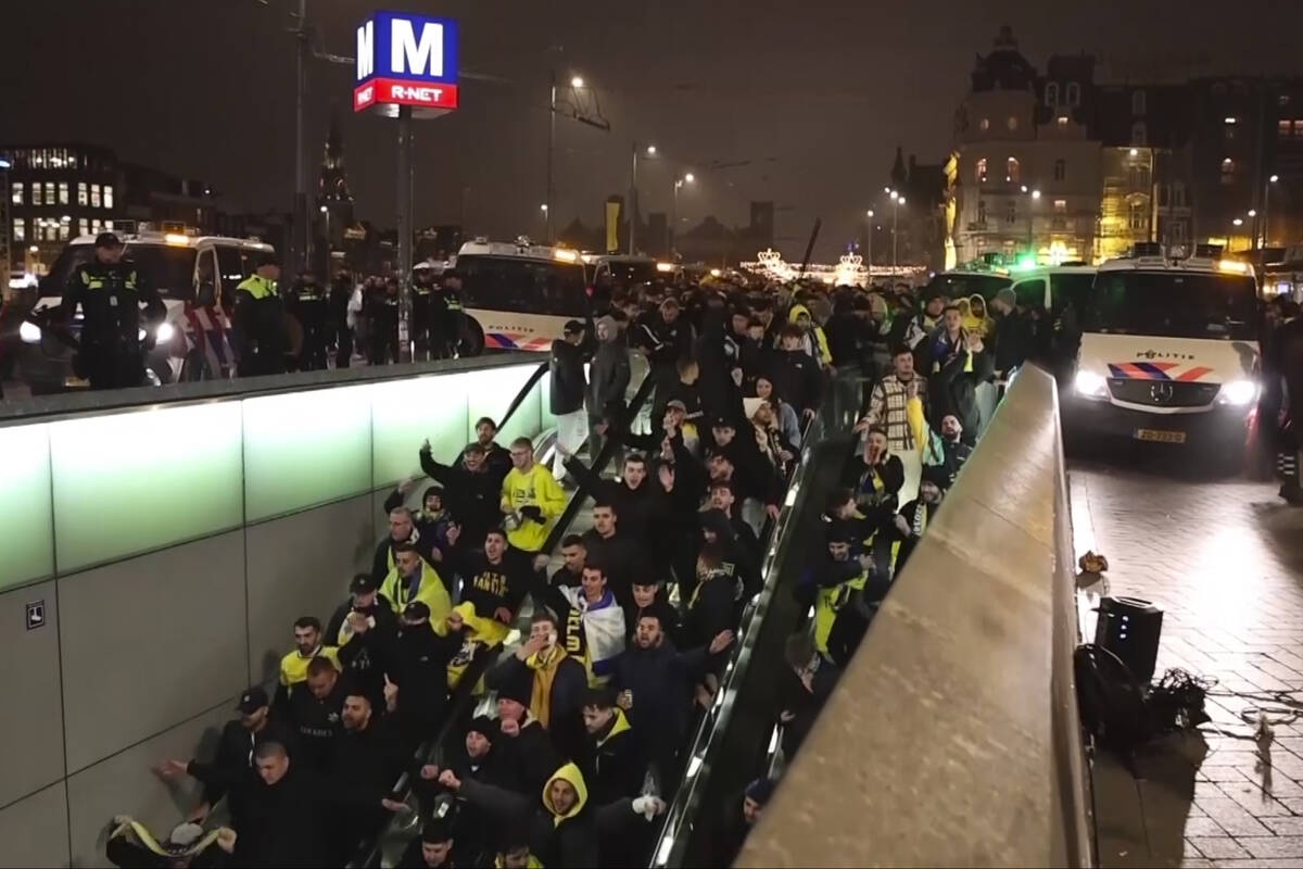 In this image taken from video, police escort Maccabi Tel Aviv supporters to the metro, after p ...