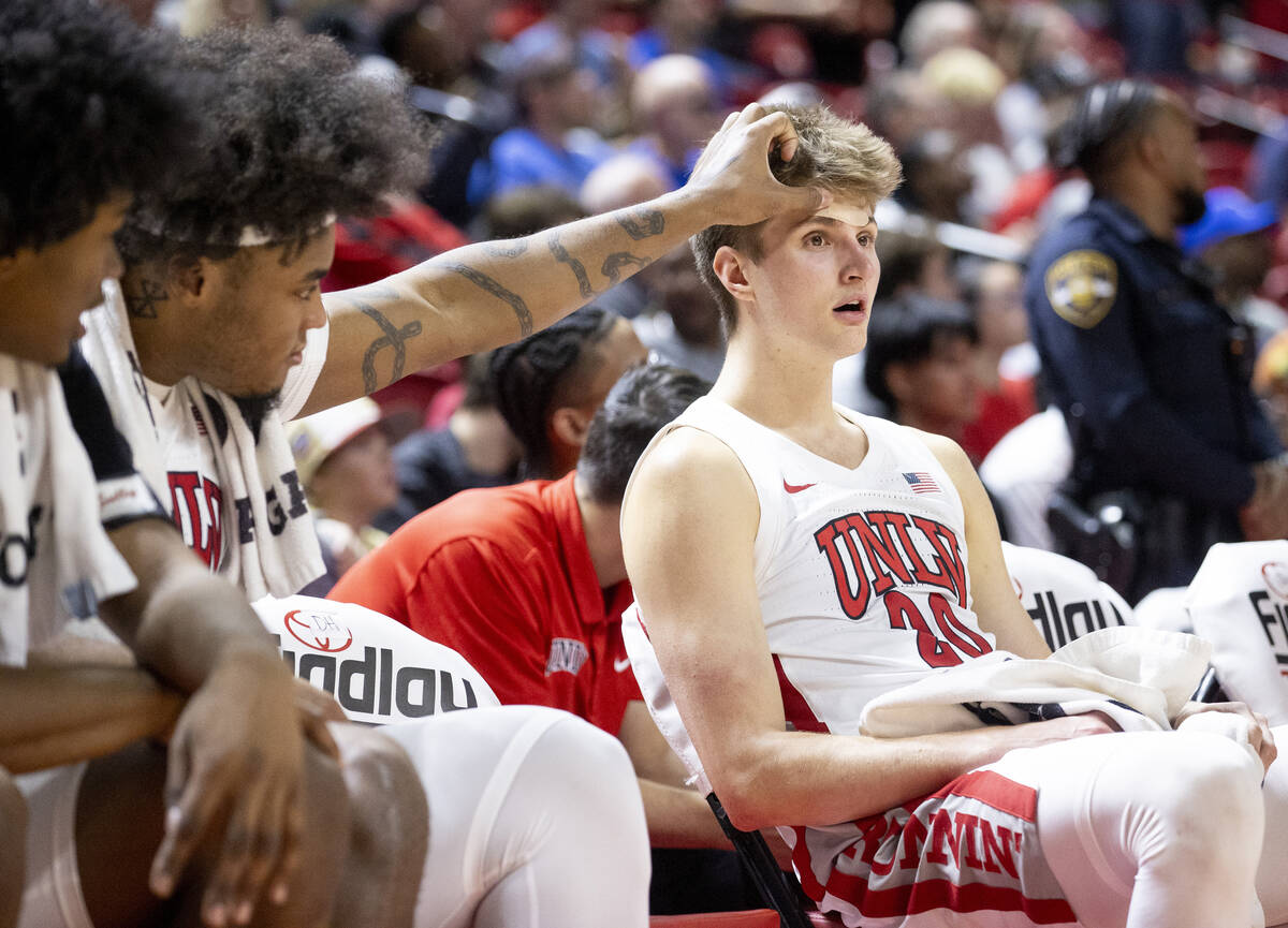 UNLV forward Rob Whaley Jr., left, fixes a bandage on guard Julian Rishwain, right, during the ...