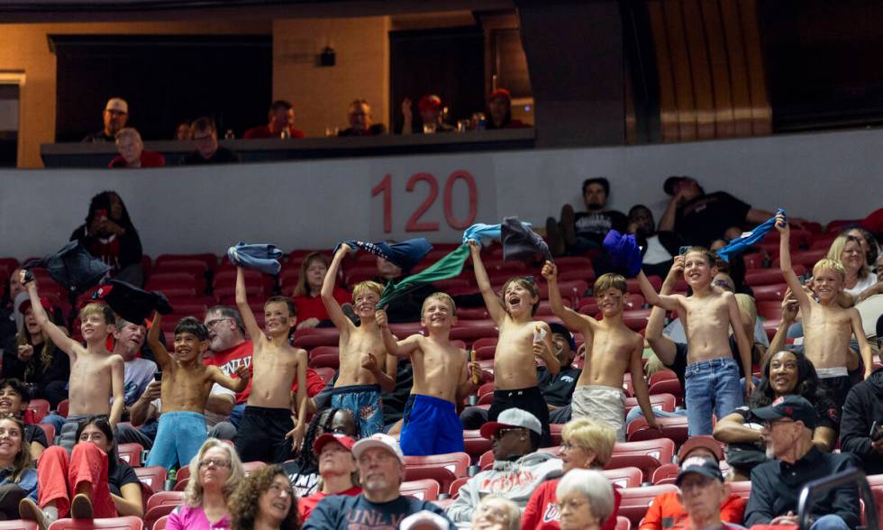 A group of young fans cheer for UNLV during the college basketball game against the Memphis Tig ...