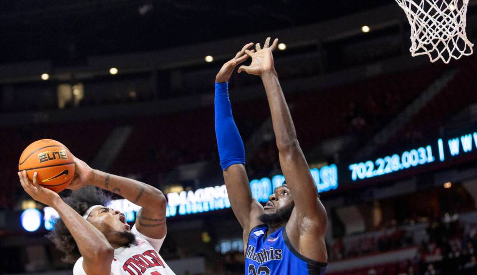 UNLV forward Rob Whaley Jr., left, attempts to shoot over Memphis Tigers center Moussa Cisse, r ...