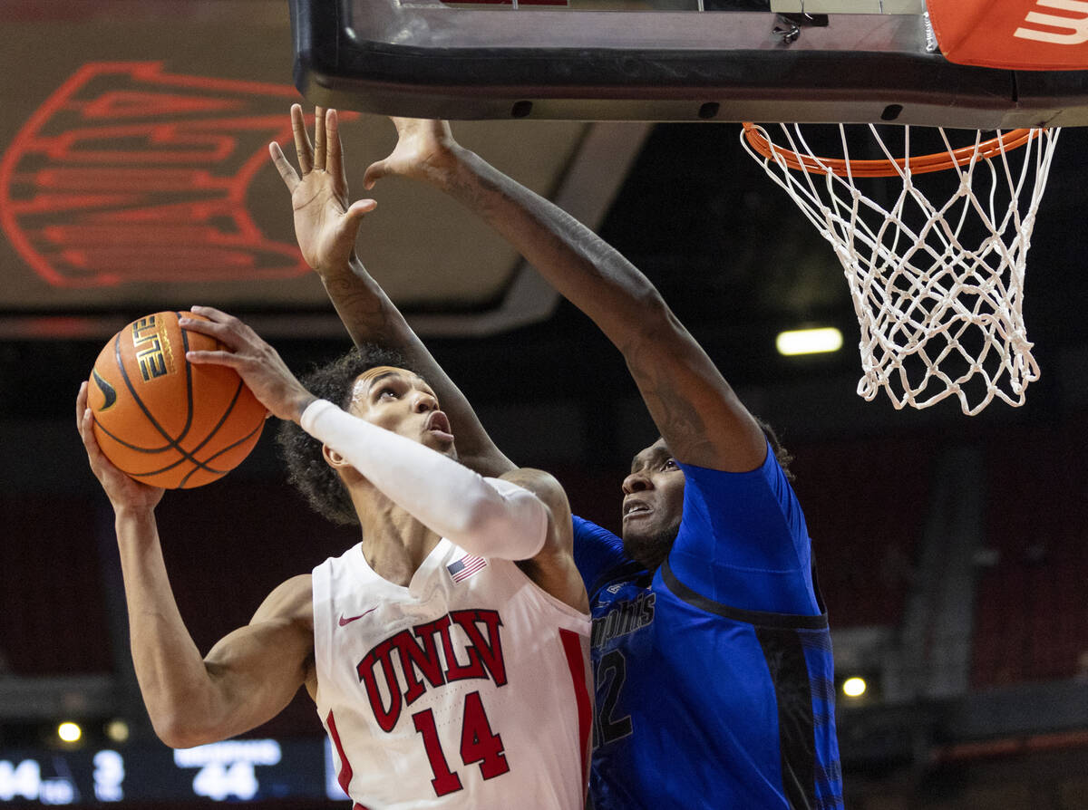 UNLV guard Jailen Bedford (14) attempts to shoot the ball over Memphis Tigers forward Dain Dain ...