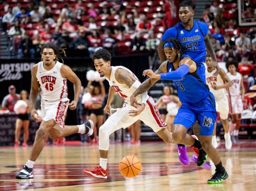 UNLV guard Jailen Bedford (14) and Memphis Tigers guard Colby Rogers (3) compete for the ball d ...