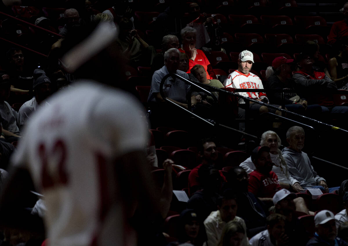 A UNLV fan watches the game during the college basketball game against the Memphis Tigers at th ...