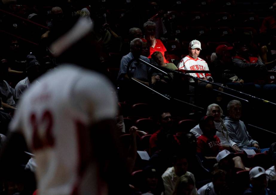 A UNLV fan watches the game during the college basketball game against the Memphis Tigers at th ...