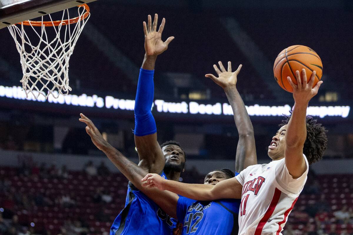 UNLV guard Dedan Thomas Jr. (11) attempts to get to the hoop during the college basketball game ...