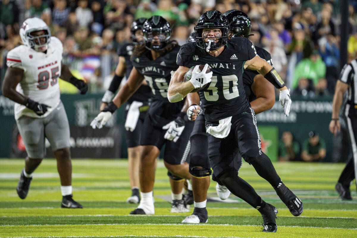 Hawaii running back Landon Sims (30) runs the ball during the second half of an NCAA college fo ...