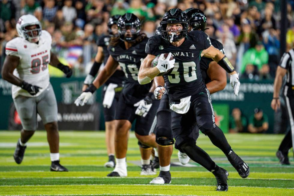 Hawaii running back Landon Sims (30) runs the ball during the second half of an NCAA college fo ...