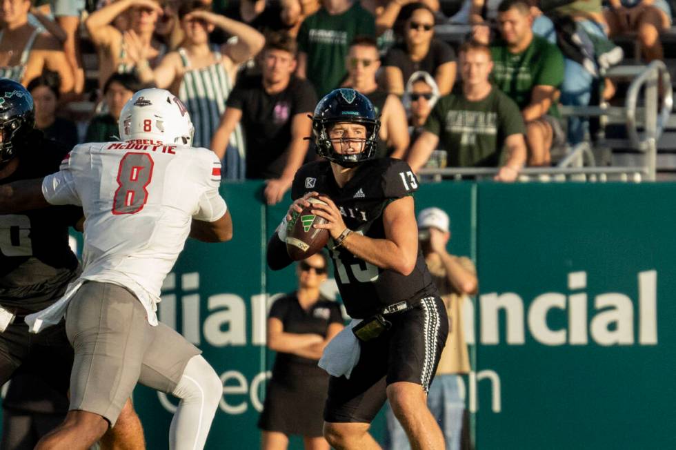 Hawaii quarterback Brayden Schager (13) looks to throw the ball during the first half of an NCA ...