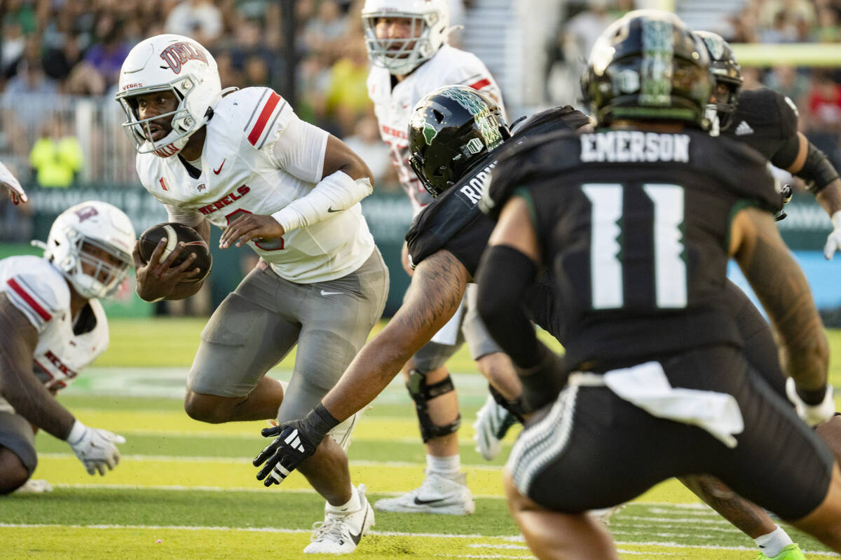 UNLV quarterback Hajj-Malik Williams (6) runs the ball during the first half of an NCAA college ...