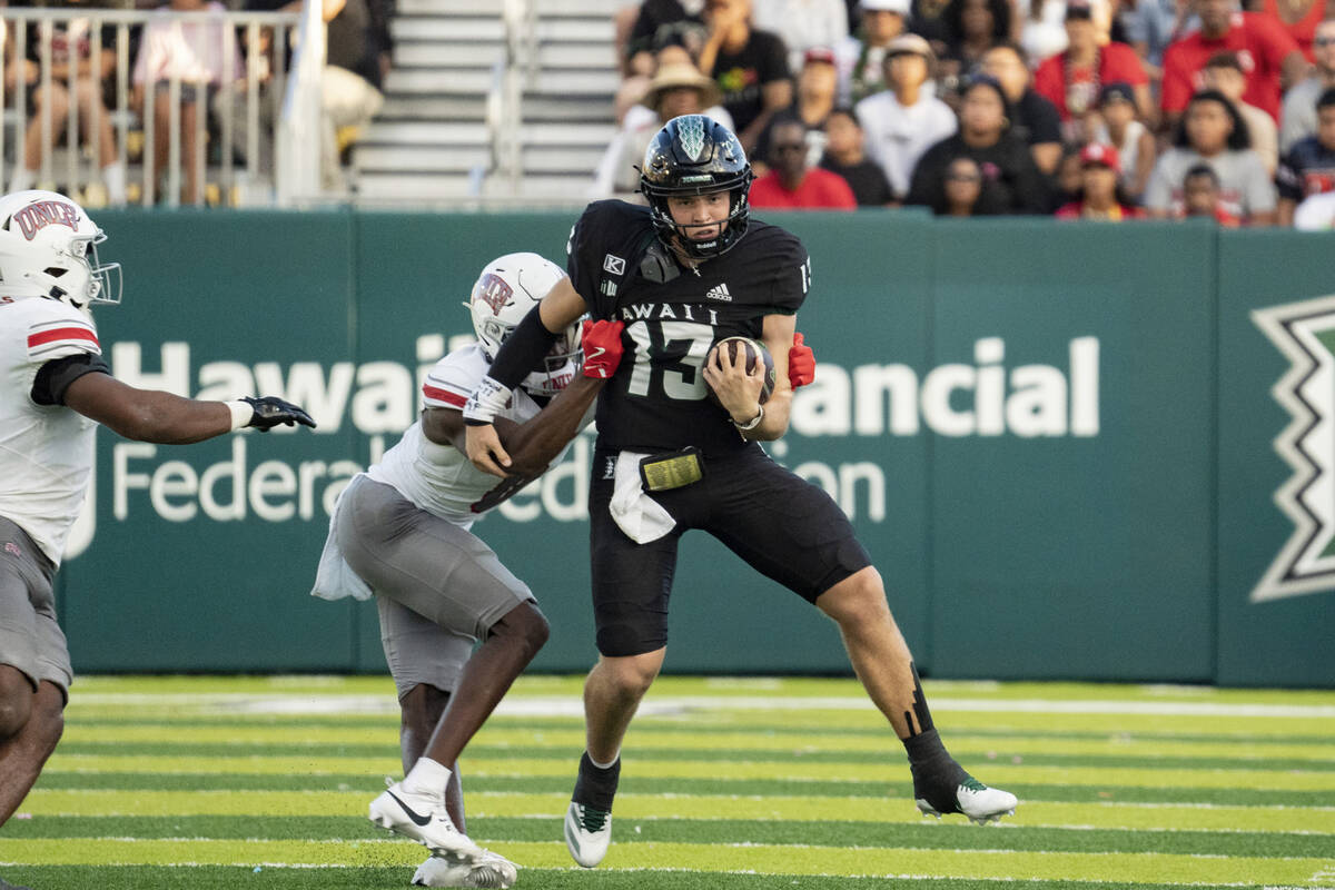 Hawaii quarterback Brayden Schager (13) runs the ball during the first half of an NCAA college ...