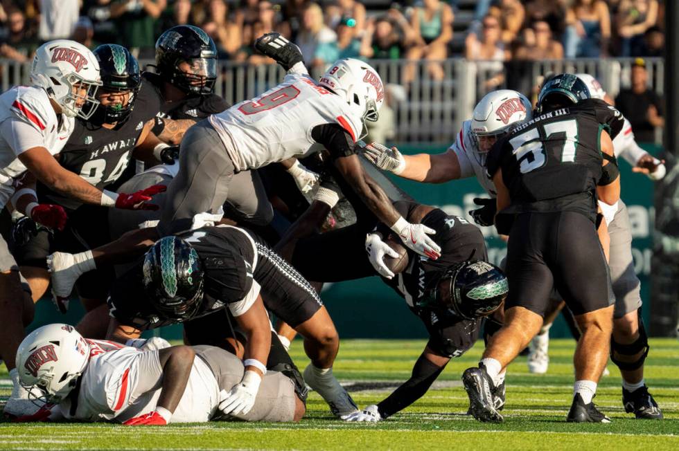 Hawaii linebacker Jamih Otis (54) holds the ball during the first half of an NCAA college footb ...